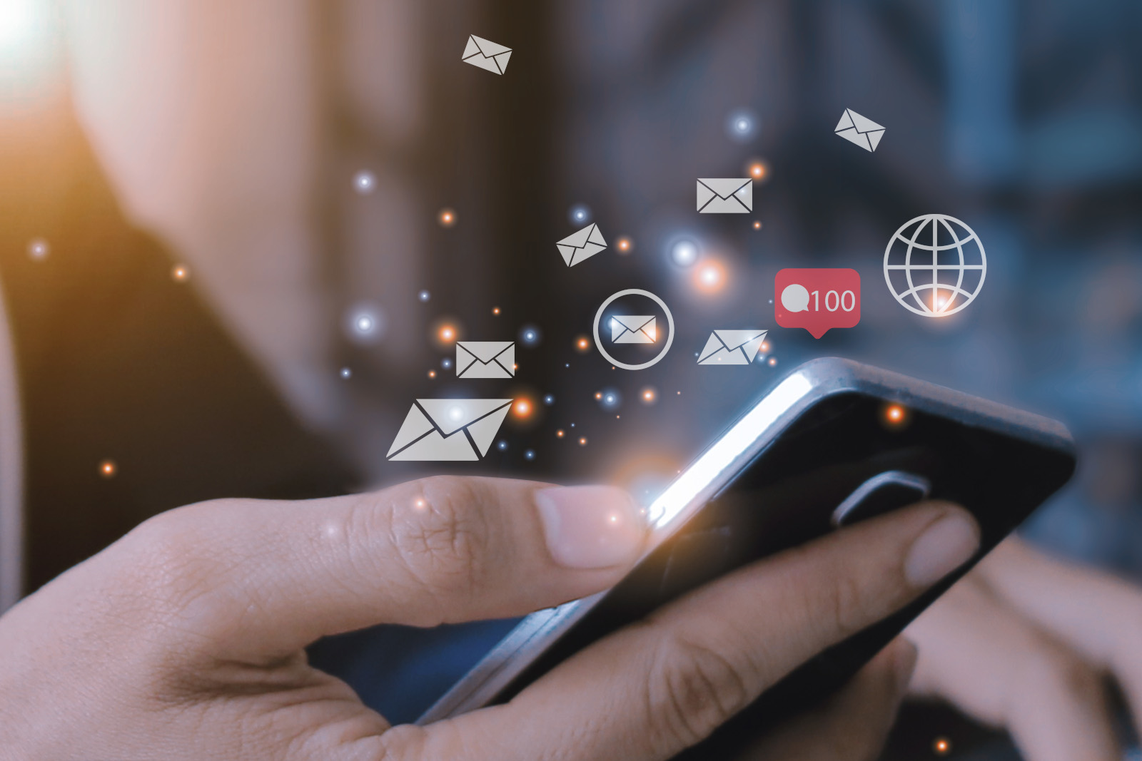 Man using smartphone with inbox e-mail icon.
