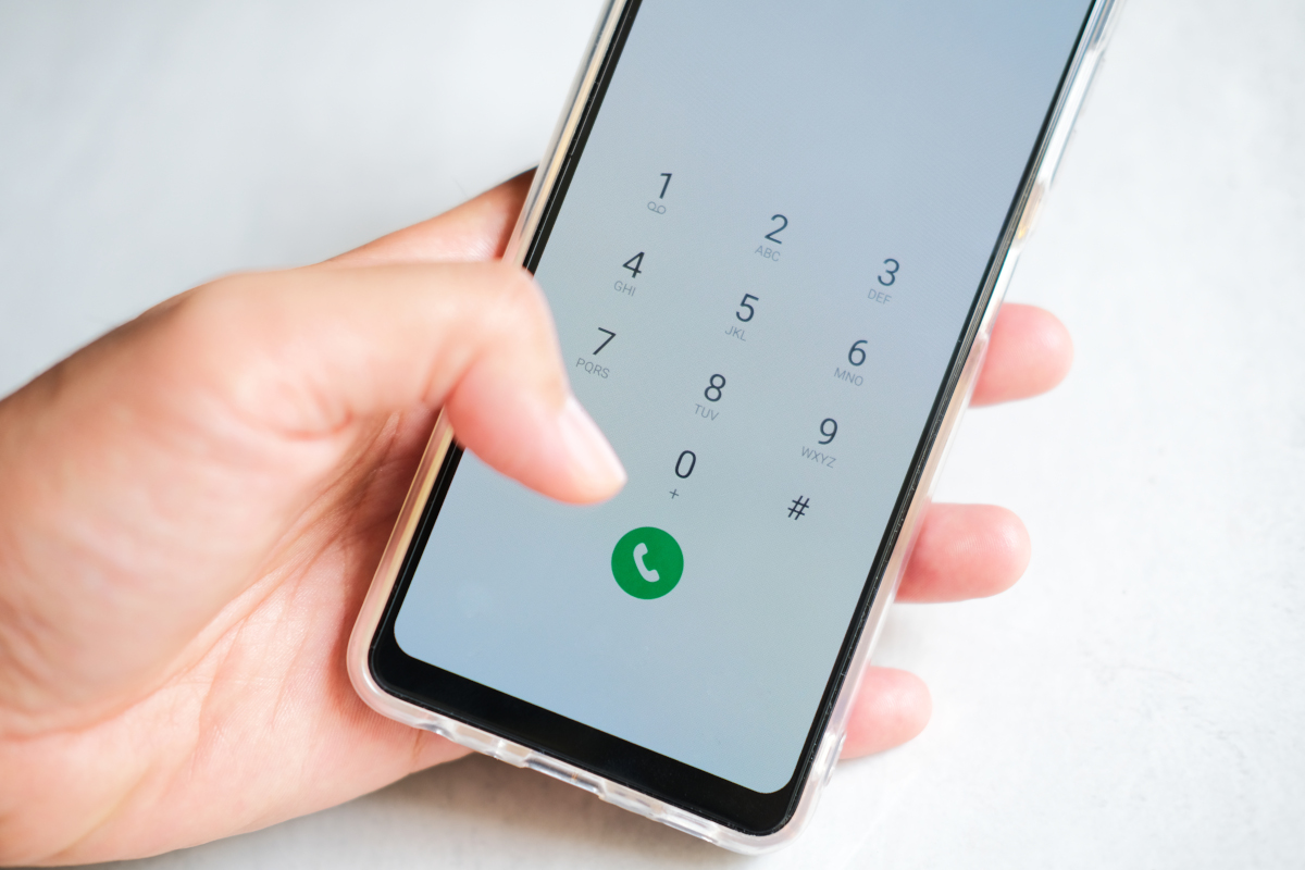 Person hand holding mobile phone and pressing call button
